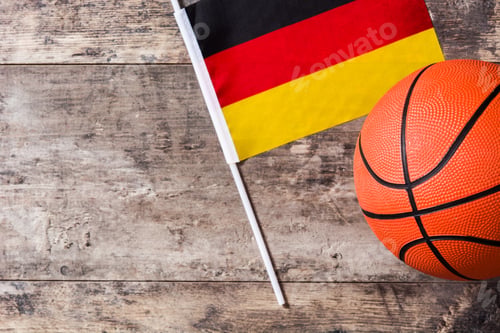 Preview: Basketball ball and german flag resting on wooden surface