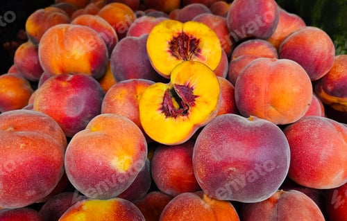 Preview: Ripe juicy peaches close-up at a market, natural fruit background