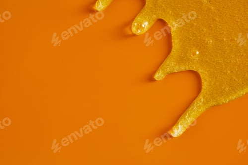 Preview: Cream liquid gel serum flowing down on yellow texture