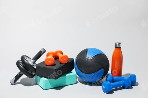 Preview: Medicine ball, dumbbells, water bottle, ab wheel and foam blocks on light grey background