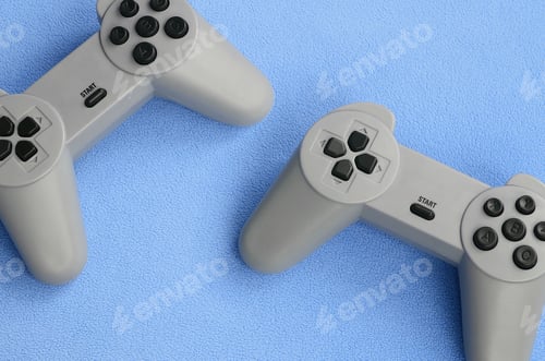 Preview: Playing games concept. Two pad joysticks lies on the blanket of furry blue fleece fabric