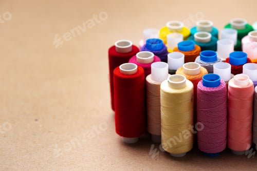 Preview: Many colored spools of threads as a background