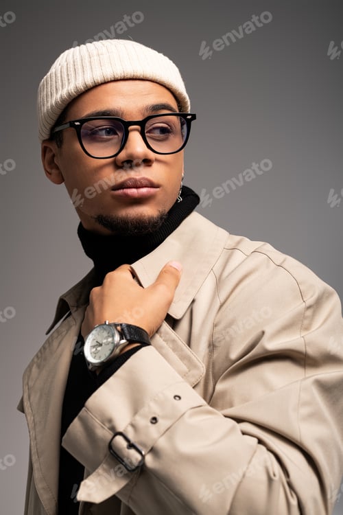 Preview: Fashionable young man showcases modern style with confidence and flair