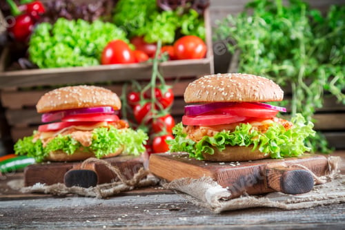 Preview: Fresh burger with chicken on old wooden table