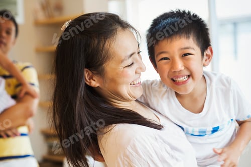 Preview: Family home. A mother holding her son, and a father holding his daughter.