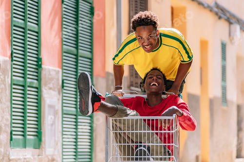 Preview: Overjoyed young black teenagers having fun in street