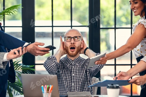Preview: Too many work. Selective focus of young business man surrounded by colleagues, each proposes a