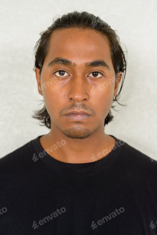Preview: Portrait of handsome young Indian man against plain background
