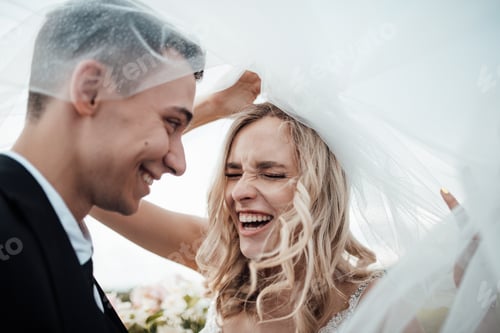 Preview: Happy authentic candid couple in love at VW cabriolet date in wedding dresses outdoor