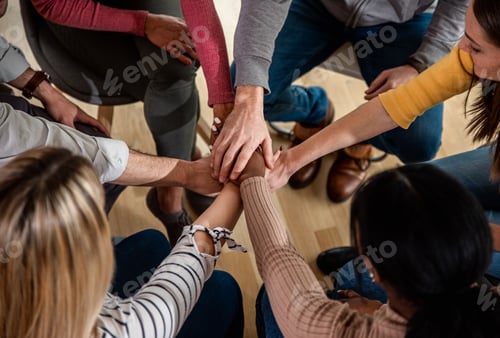 Preview: Diverse group of people sitting in circle in group therapy session.