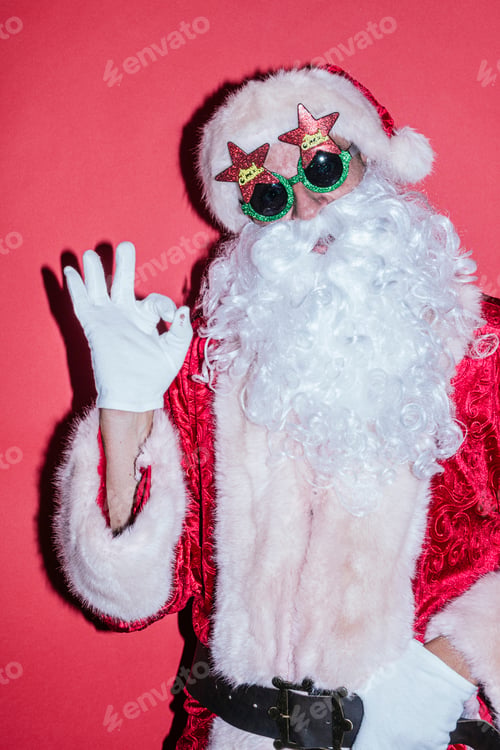 Preview: Man dressed as Santa Claus gesturing with funny glasses