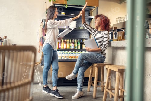 Preview: Curly friend giving high five to her business partner