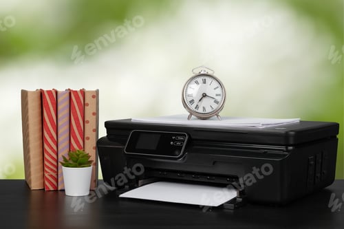 Preview: Stack of books and home printer against blurred background