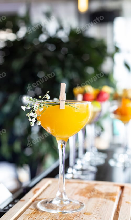 Preview: Fresh Orange Cocktail Garnished with White Flowers
