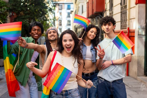 Preview: Young activists showing rainbow flags at pride parade celebrating lgbtq plus community