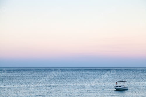 Preview: boat in sea in blue and pink summer twilight