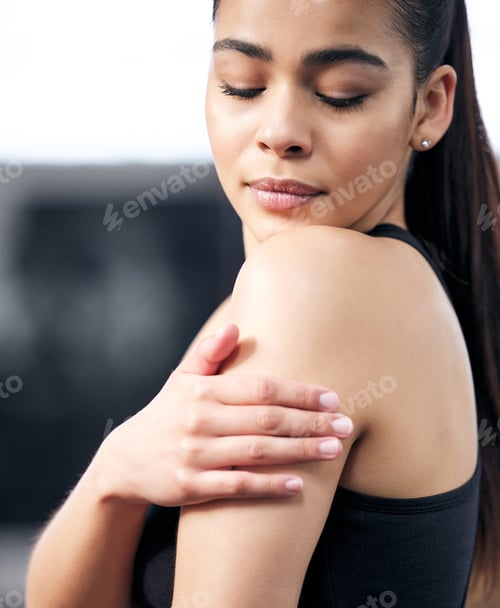 Preview: Go hard, just dont get hurt. Shot of a young woman experiencing pain during her workout in a gym.