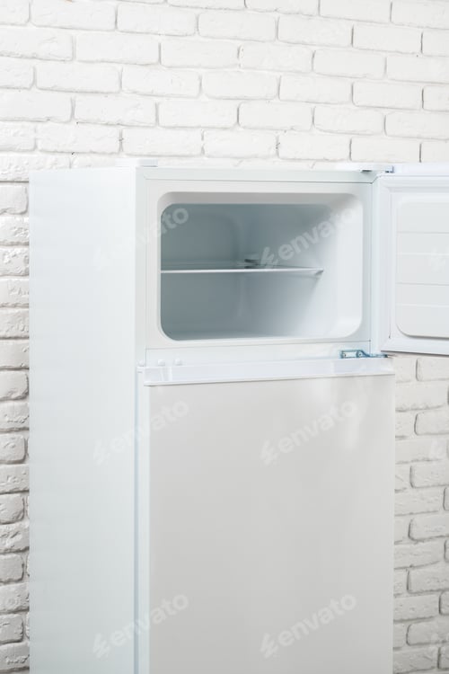 Preview: White Refrigerator Open Against Brick Wall