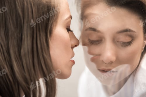 Preview: young sensual caucasian girlfriends and looking at each other