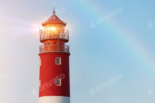 Preview: Lighthouse in Baltiysk port. Beautiful rainbow and beacon lights. Clean blue sky, copy space.