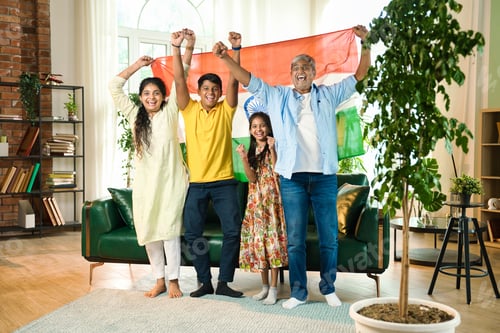 Preview: Indian family celebrating victory on TV, waving the tricolor flag joyfully from their sofa