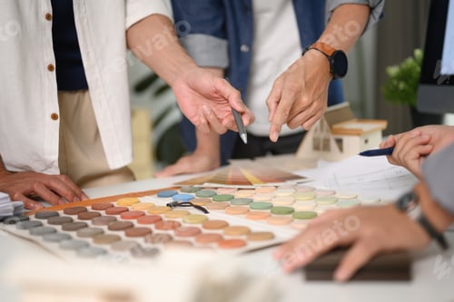Preview: Group of designers of interior choosing material samples, working together at creative office
