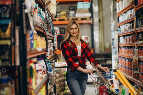 Preview: happy young woman shopping at hardware store