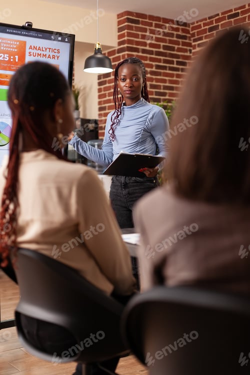 Preview: Diverse businesspeople analyzing marketing graph on monitor