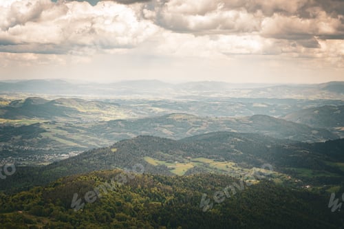 Preview: Rolling green hills landscape with cloudy sky