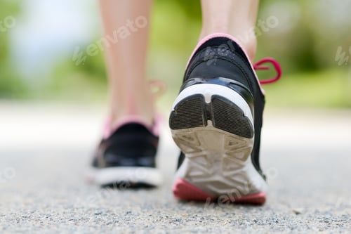 Preview: Runner feet running on road closeup on shoe