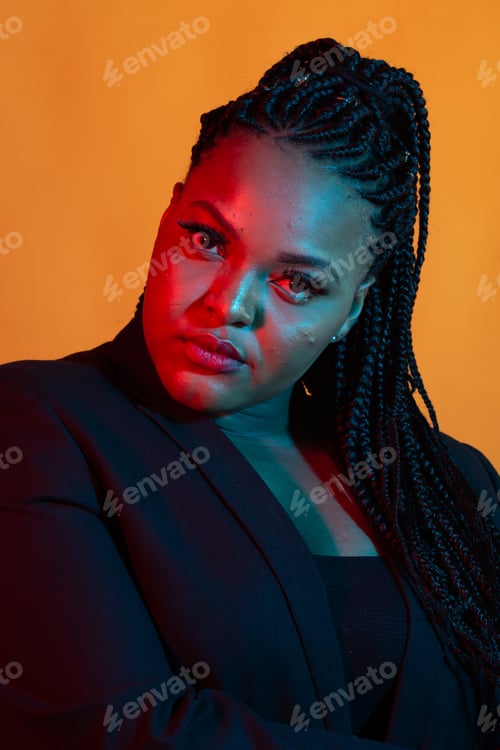 Preview: Portrait of beautiful young African American woman with afro and glamour makeup. Studio shot