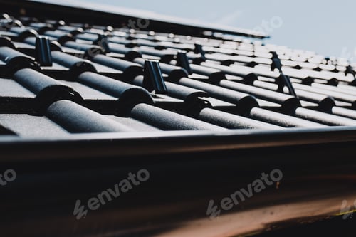 Preview: Snow guard supporting metal roof tiles on residential building
