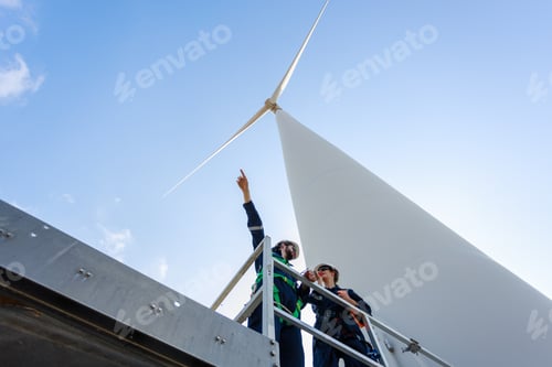 Preview: Team engineer wind turbine worker safety uniform survey discuss operational planning windmill