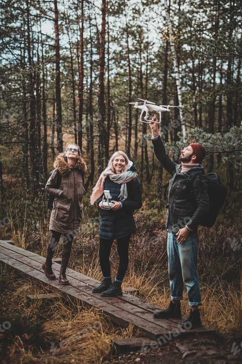 Preview: Group of friends are enjoying autumn hike in forest