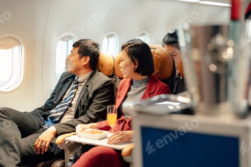 Preview: Smiling elegant asian woman talking while passenger seat.