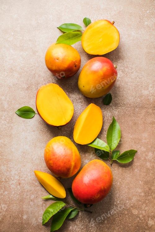 Preview: Mango background design concept. Top view of fresh mango fruit pattern with leaves on table.