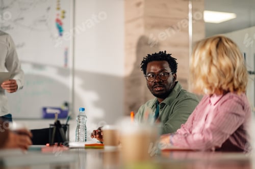 Preview: Diverse business team collaborating on project in modern office