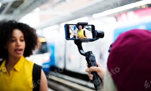 Preview: Young adult woman traveling and vlogging social media concept