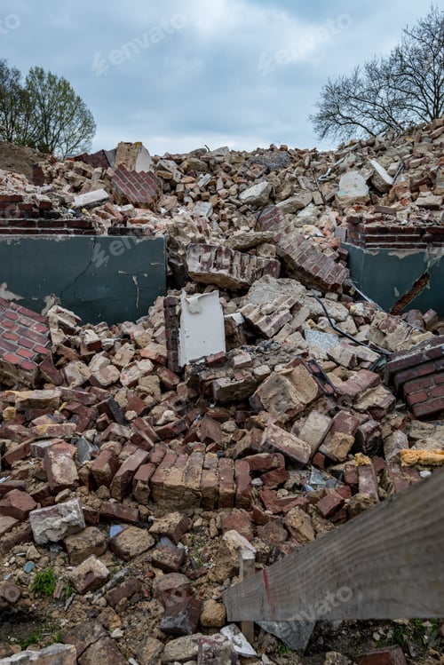 Preview: Vertical shot of a pile of bricks at the foundation of a demolished building