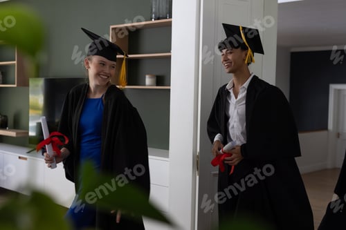 Preview: Graduating teens in gowns holding diplomas, celebrating achievement joyfully at home
