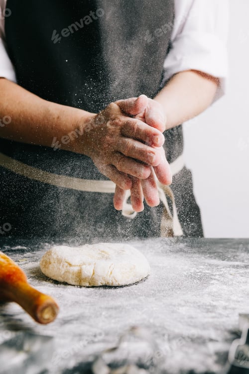 Preview: Person beating up dough with flour
