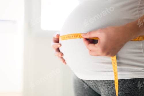 Preview: Pregnant woman measuring belly