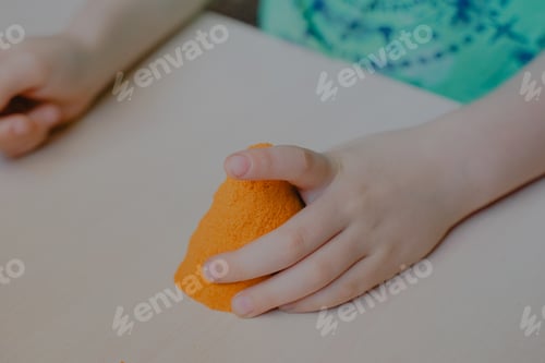 Preview: child sculpts a plasticine tower