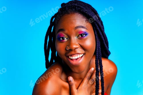 Preview: african american woman with gorgeus bright color make up feels proud and self confident in blue wall