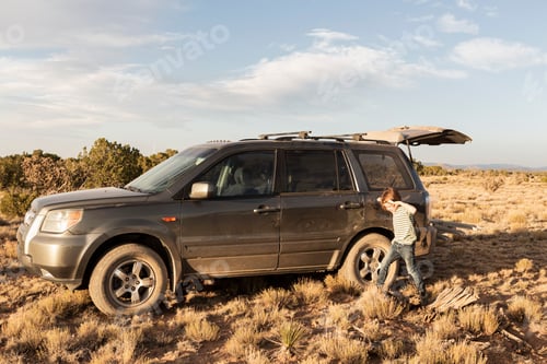 Preview: young boy with SUV, Galisteo Basin, Santa Fe, NM.