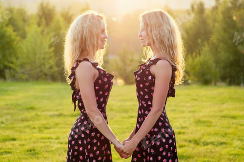 Preview: two sisters twins beautiful curly blonde happy young toothy smile women in stylish dress