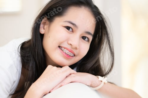 Preview: Portrait of a young asian woman with braces on her teeth