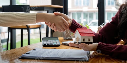 Preview: Estate agent and customer shaking hands after finished contract after about home insurance and