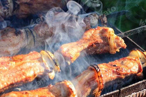 Preview: Barbecue skewers with juicy meat cooking in open air in summer. Food background. N