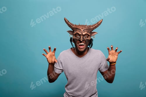 Preview: Young person wearing traditional indigenous face mask